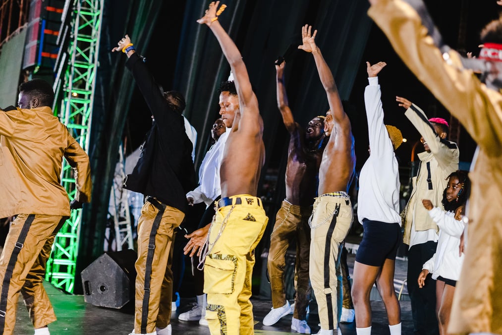 Performers Dancing on Stage at Music Festival